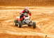 2004 Honda TRX 400 EX - An ATV rider navigates a dirt track, kicking up dust as they go.