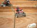 2004 Honda TRX 400 EX - A rider on a red ATV navigates a dirt track during a race.