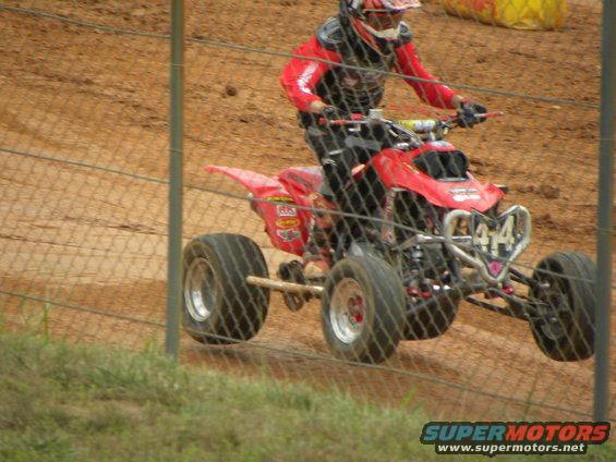 Red ATV with number 44 on front, rider in red gear. 2004 Honda TRX 400 EX