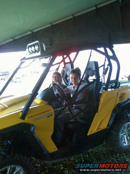 Yellow side-by-side vehicle with two girls in the front seats