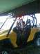 2003 Yamaha RAPTOR 80 - Two young girls sit in a yellow side-by-side vehicle, one appearing to steer.