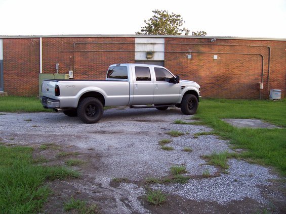 Silver 2008 Ford F-250 Super Duty pickup truck parked on gravel lot