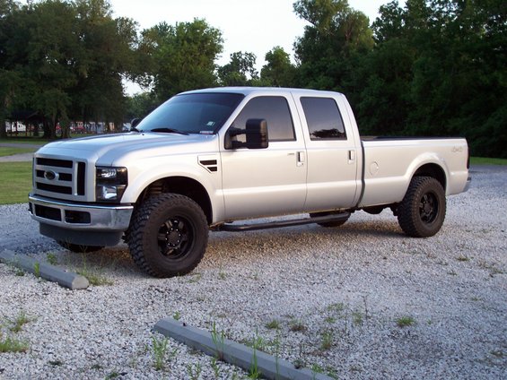 Silver 2008 Ford F-250 Super Duty pickup truck parked on gravel