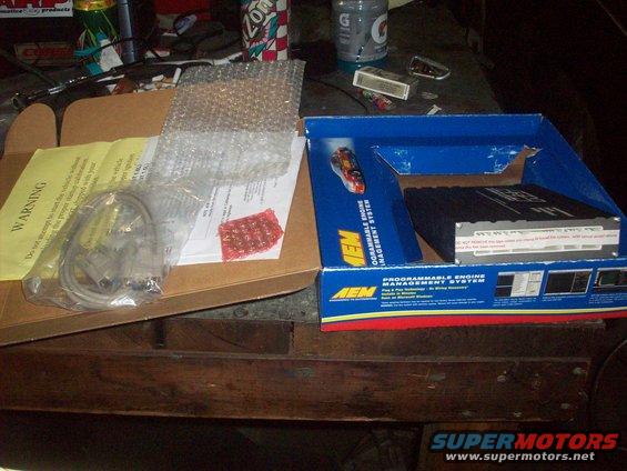 AEM Programmable Engine Management System box with wiring harness and instructions