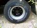1989 Ford Bronco - A close-up view of a tire and wheel assembly on a vehicle.