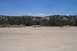 1995 Ford Bronco - A wide view of a dry, arid landscape with sparse vegetation and hills in the background.