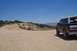 1995 Ford Bronco - This 1995 Ford Bronco is seen from the rear, parked on a dusty, off-road path under a clear blue sky.