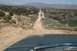 1995 Ford Bronco - View from inside a vehicle driving on a dirt road through a desert landscape.