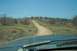 1995 Ford Bronco - Driving down a dusty road in a dry, scrubby landscape.