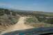 1995 Ford Bronco - View from inside a vehicle looking out at a desert scene with a dirt road ahead. Supermotors.net logo is present.