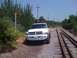 2001 Dodge 1500 - A white Dodge Ram pickup truck is parked beside a set of railroad tracks under a clear blue sky.