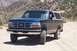1995 Ford Bronco - This 1995 Ford Bronco is shown in a three-quarter front view on a dusty, off-road path.