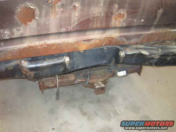 Rusted vehicle frame section with a trailer hitch receiver and wiring