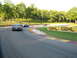 1985 Ford Mustang - Multiple cars race on a track with GEHL advertising banners visible.