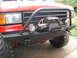 1989 Ford Bronco - This vehicle features an aftermarket bumper with a winch and auxiliary lights.