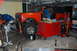 1994 Ford Bronco - Orange International Scout II in a garage, undergoing work. A motorcycle is parked nearby.