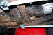 1994 Ford Bronco - The undercarriage of a vehicle is shown, focusing on the transmission and transfer case assembly.