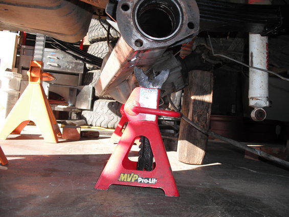Red jack stand with MVP Pro-Lift logo under vehicle exhaust pipe