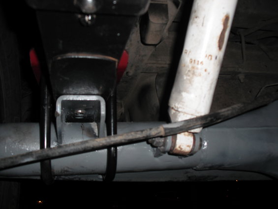 Close-up of rear axle with shock absorber and suspension bracket