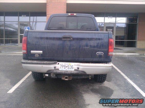 Dark blue 2005 Ford F-250 pickup truck rear view, dirty exterior, chrome bumper, license plate 7PB-936