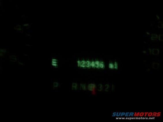 Dashboard gauges showing 123456 miles and PRND321 gear selection