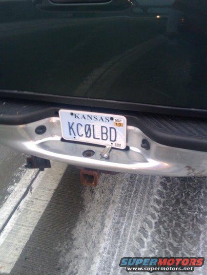Rear bumper of a dark colored truck with a Kansas license plate that reads KCØLBD