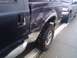 2005 Ford F-250 - This 2005 Ford F-250 shows extensive damage to its rear quarter panel and side. The FX4 badging is visible.