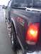 2005 Ford F-250 - Rear view of a dark colored 2005 Ford F-250 pickup truck in snowy conditions.
