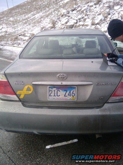 Gray Toyota Camry rear with yellow ribbon sticker and license plate 21C Z46