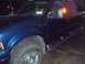 2005 Ford F-250 - This blue 2005 Ford F-250 pickup truck is shown from a 3q-front angle.