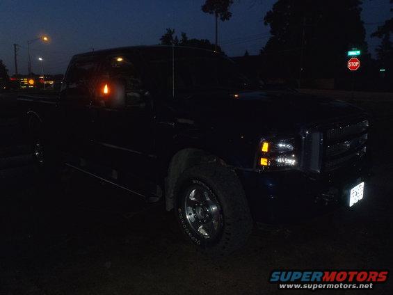 Dark blue 2005 Ford F-250 pickup truck, 3q front view at night
