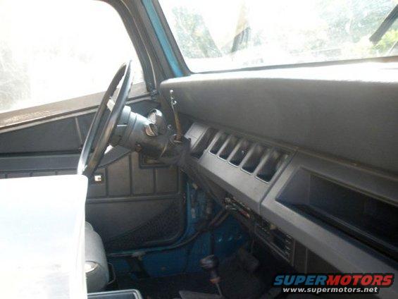 Jeep interior with dashboard, steering wheel, and gear shifter visible