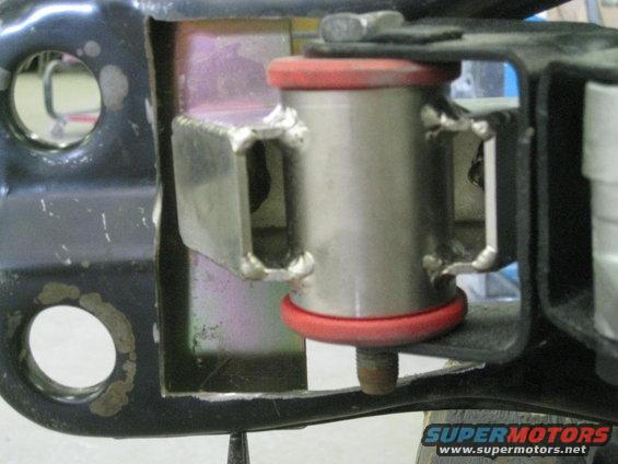 Suspension bushing with red rubber isolators and metal bracket