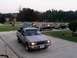 1979 Ford Bronco - A lineup of four pickup trucks is visible in a suburban driveway during the day.