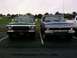 1979 Ford Bronco - Two vintage pickup trucks are parked in a lot under an overcast sky.