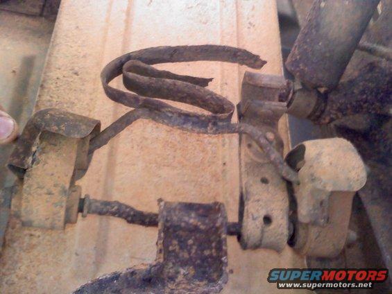 rusted suspension parts, possibly from a truck or SUV