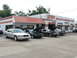 2004 Mercury Marauder - Several cars are parked outside a repair shop, with some hoods open, suggesting service work.