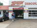 2004 Mercury Marauder - A man sets up a canopy outside a Speedy Lube while a Ford Mustang is parked nearby.