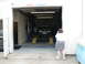 2004 Mercury Marauder - A dark sedan is positioned on a car lift inside a garage, with "SPEEDY'S Lie Detector" visible above the entrance.