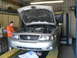 2004 Mercury Marauder - Mechanics work on a 2004 Mercury Marauder in a garage bay.