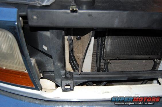Cooler hoses run through holes drilled in the rubber air dam and an existing hole in the core support. Hoses are wrapped in wire loom to prevent chafing.