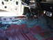 1973 Ford Ranchero - Interior of a car undergoing restoration, with wiring and floor pan exposed.