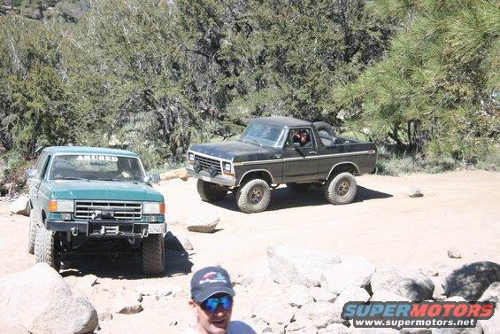 Green Ford Bronco with winch and "ABUSED" sticker on windshield