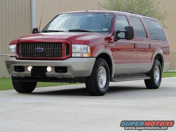 Red 2003 Ford Excursion SUV parked on concrete, front 3/4 view