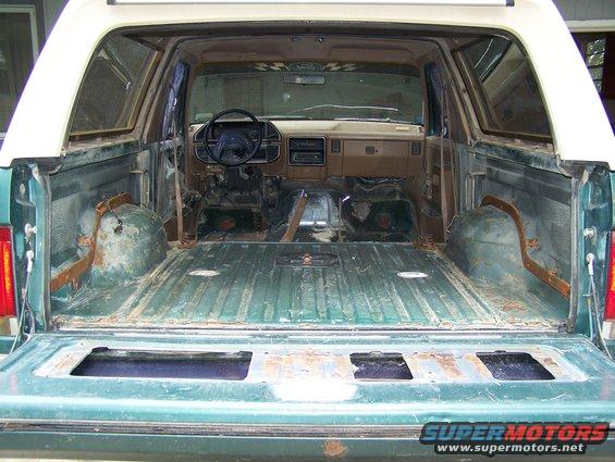 Green 1989 Ford Bronco interior and cargo area, viewed from rear with tailgate down
