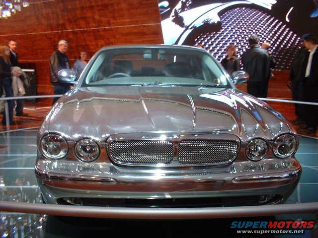 Front view of a chrome Jaguar XJ at a car show