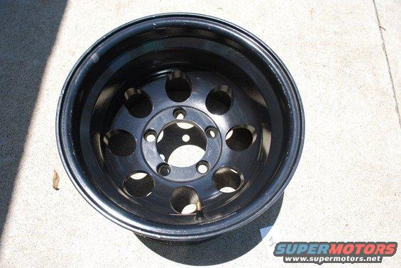 Black steel wheel with 5 pairs of circular cutouts