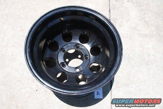Black off-road wheel with 5 pairs of circular cutouts