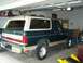 1989 Ford Bronco - This 1989 Ford Bronco, seen in a garage, features a two-tone green and tan paint scheme.