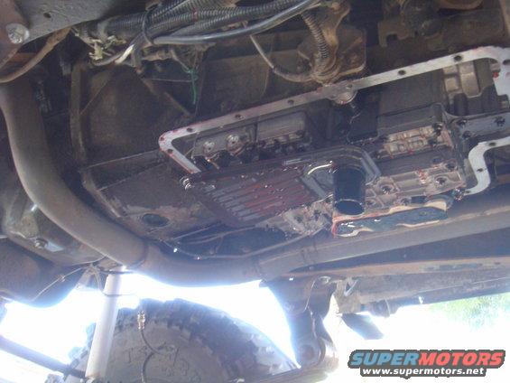 Transmission pan and filter removed, showing fluid and internal components